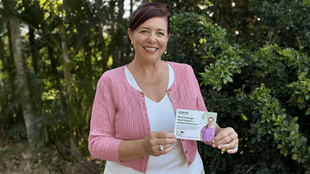 STEPS Pathways Charity Manager Katrina May holding 100 Connect card