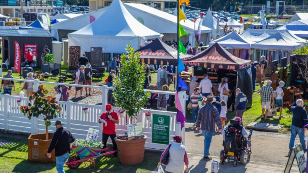 Queensland Garden Show event grounds filled with visitors exploring exhibitor stalls, marquees, garden displays and plant vendors in a vibrant outdoor setting.