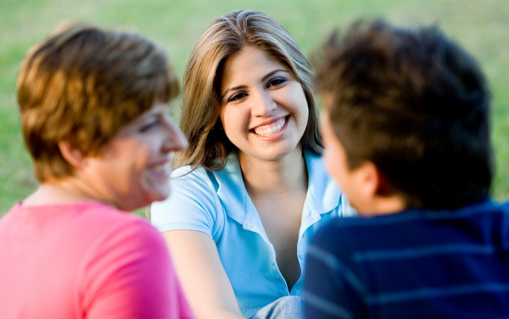 Smiling young woman with group