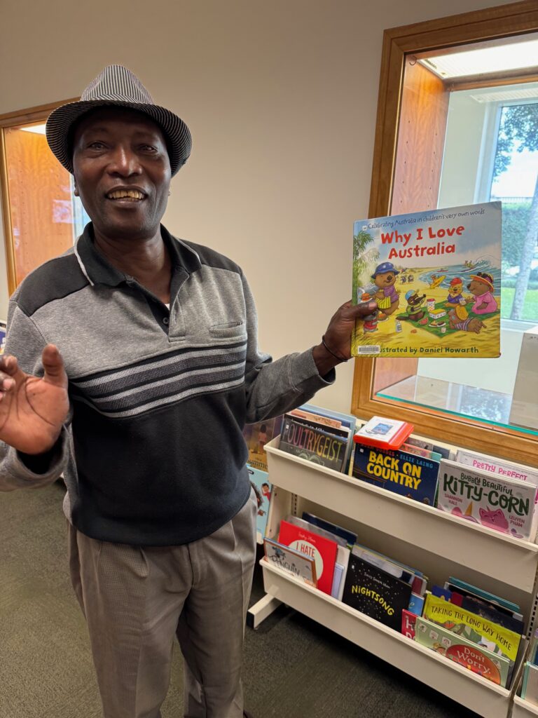 SEE student holding a book titled "Why I Love Australia"