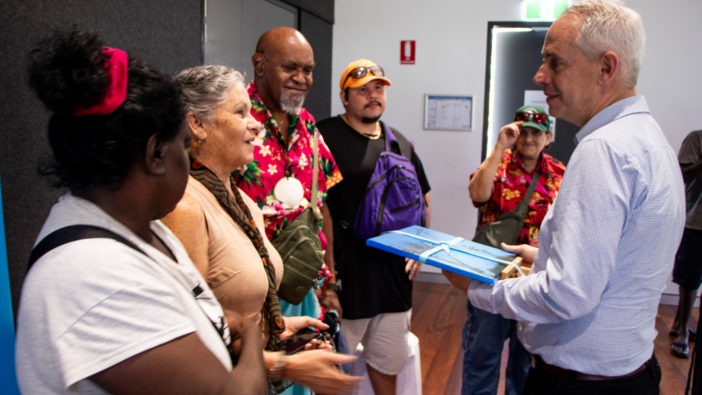 The Hon Andrew Giles MP, Minister for Skills and Training accepts a painting from five STEPS SEE Program art class participants in Palmerston.