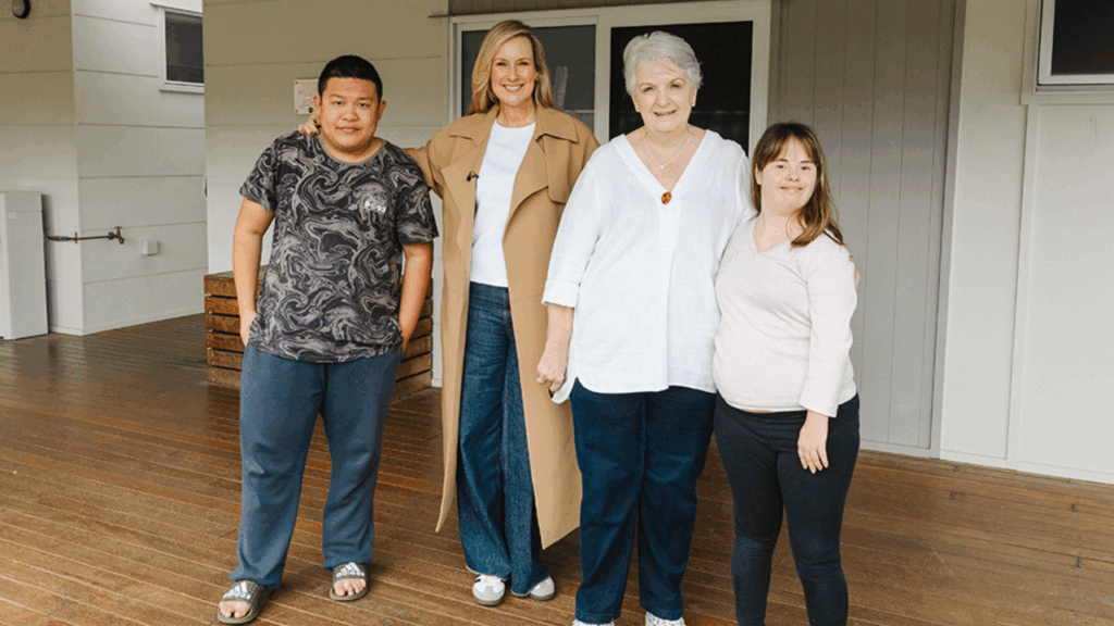 STEPS Pathways College Ambassador Melissa Doyle and STEPS Managing Director Carmel Crouch standing with STEPS Pathways College students, all smiling at the camera.