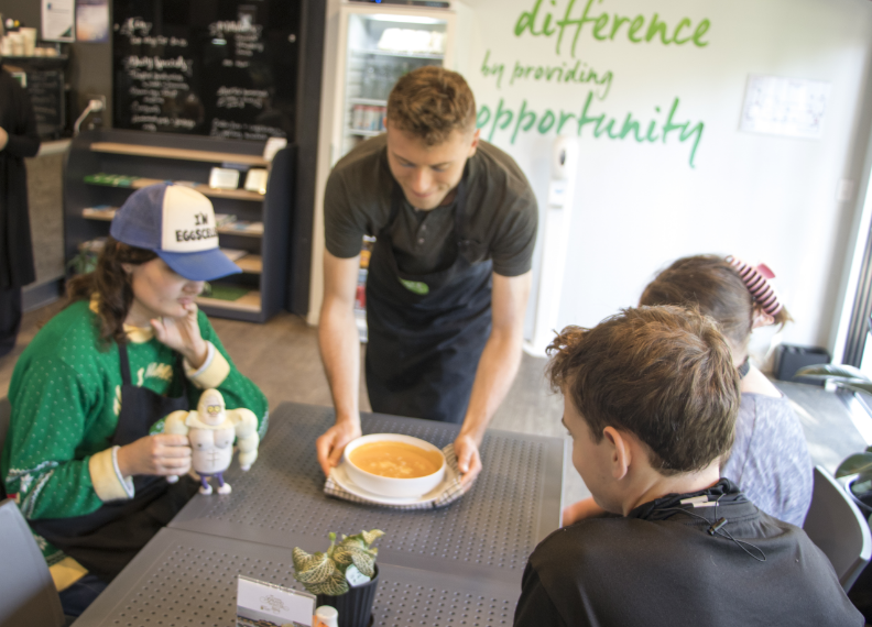 Customers of the STEPS Café on George with a bowl of fresh soup