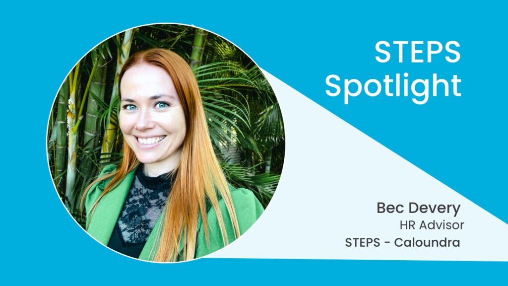 A photo of Bec Devery, smiling at the camera in front of trees and greenery. She has fair skin, straight orange hair, and is wearing a green blazer jacket over a black lacy top. Next to the photo is some text: STEPS Spotlight, Bec Devery, HR Advisor, STEPS – Caloundra.
