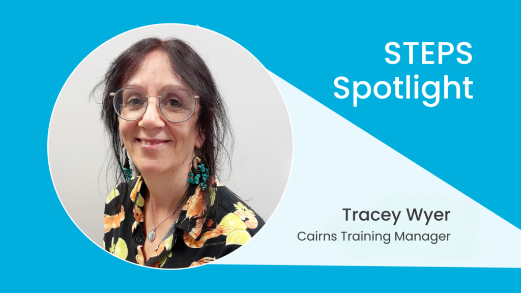 A picture of a woman in a patterned button-up top. She is wearing glasses. The photo is surrounded by a bright blue background, with text reading: STEPS Spotlight - Tracey Wyer - Cairns Training Manager.