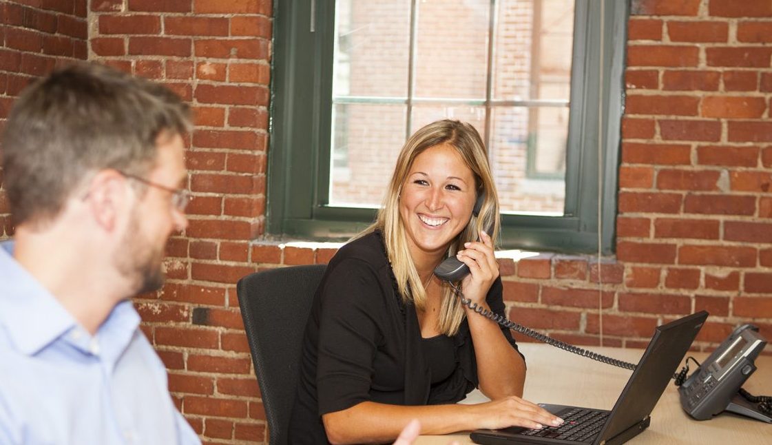 Smiling woman talks on phone