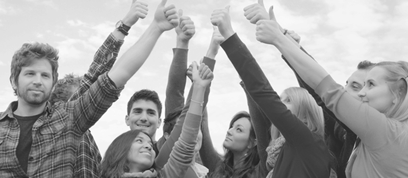 in-the-community-group-shot Group of young adults with hands in the air