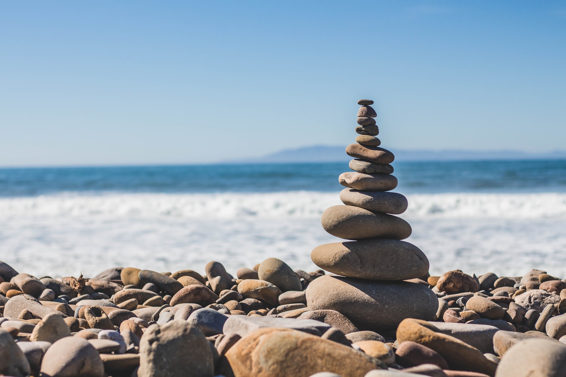 balancing stones on beach