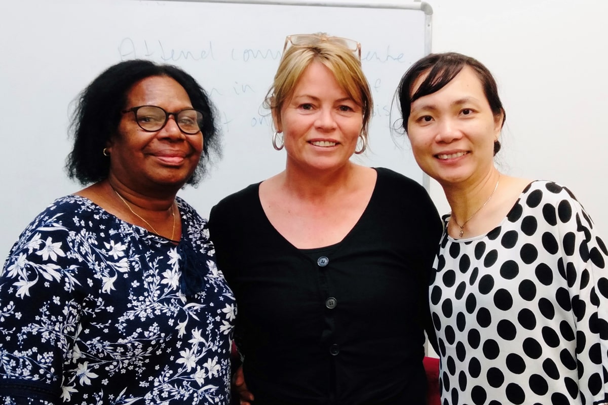 Photo of three people smiling at camera